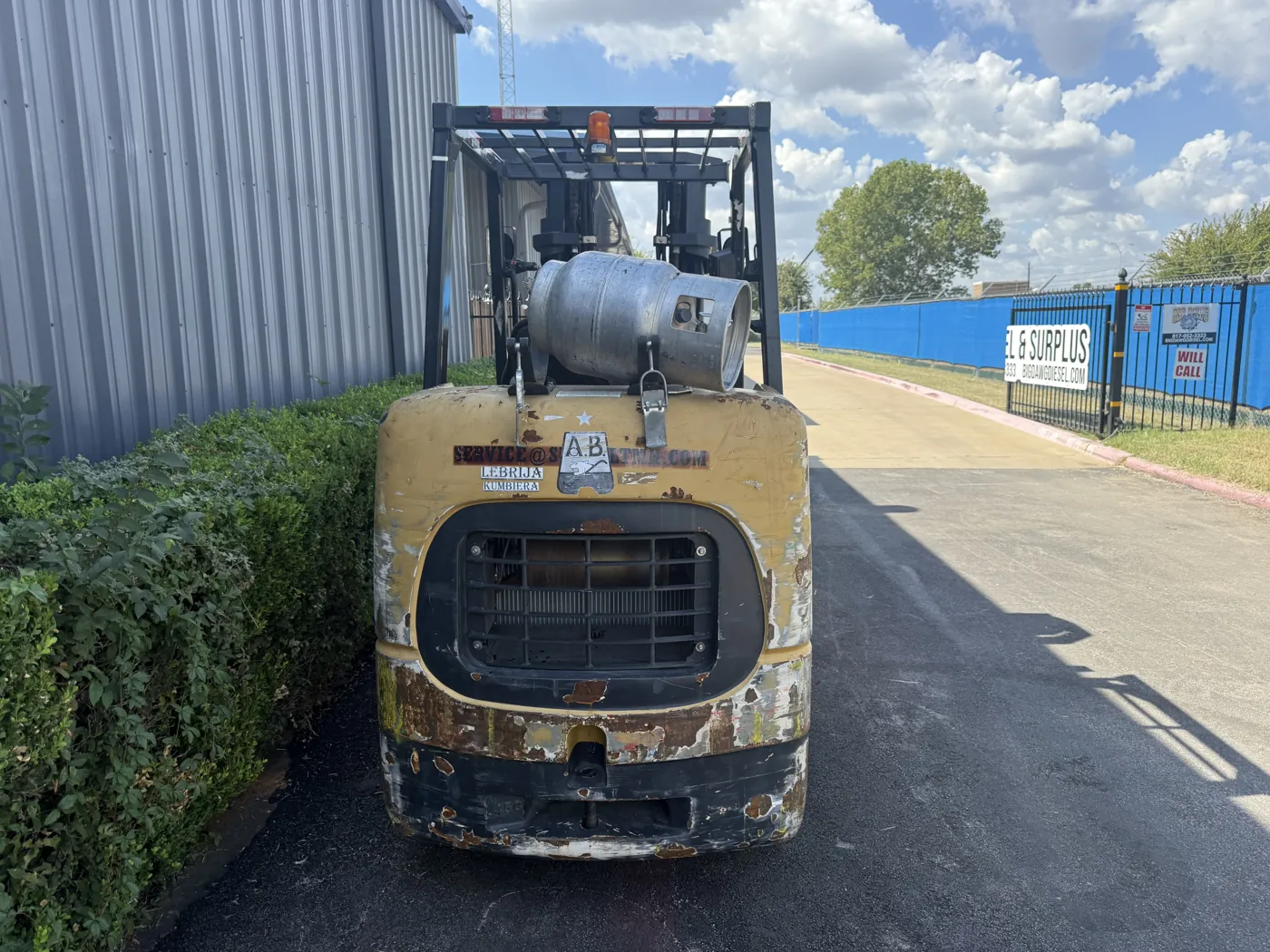 Forklift rear before refurbishment, with peeling paint and rust