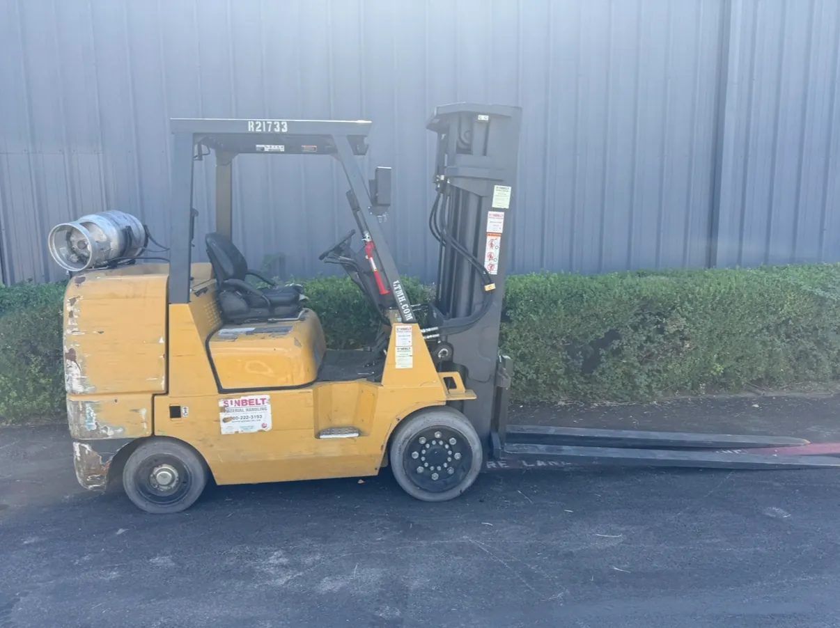 Forklift side view before refurbishment, faded and worn