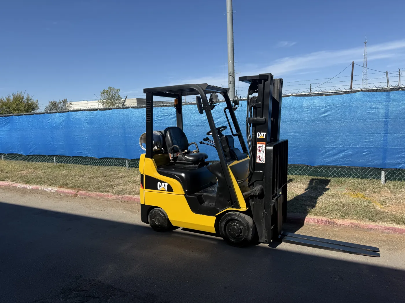 Same CAT forklift after refurbishment, with fresh paint and new decals