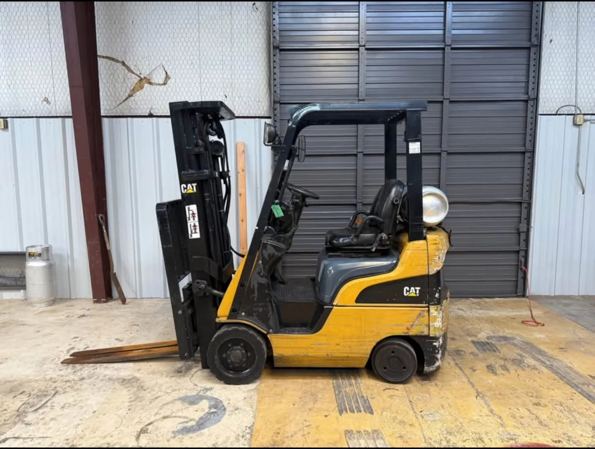 CAT forklift before refurbishment, with worn and peeling paint