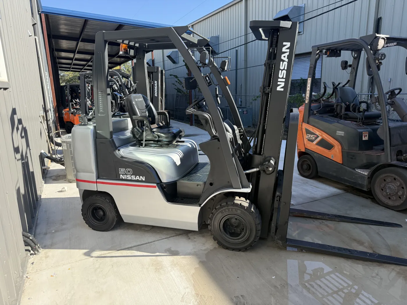 Same Nissan forklift after refurbishment, with fresh paint and new decals