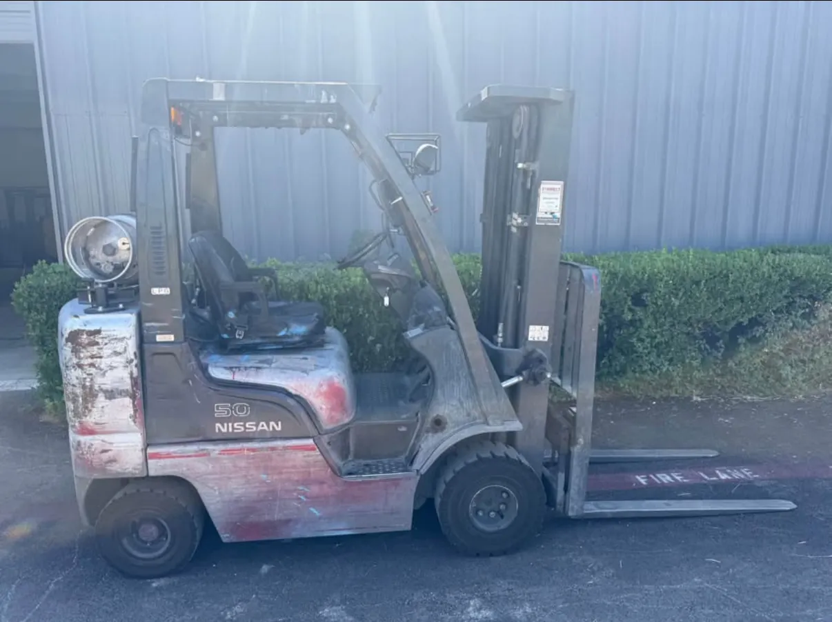 Nissan forklift before refurbishment, with scraped and faded paint