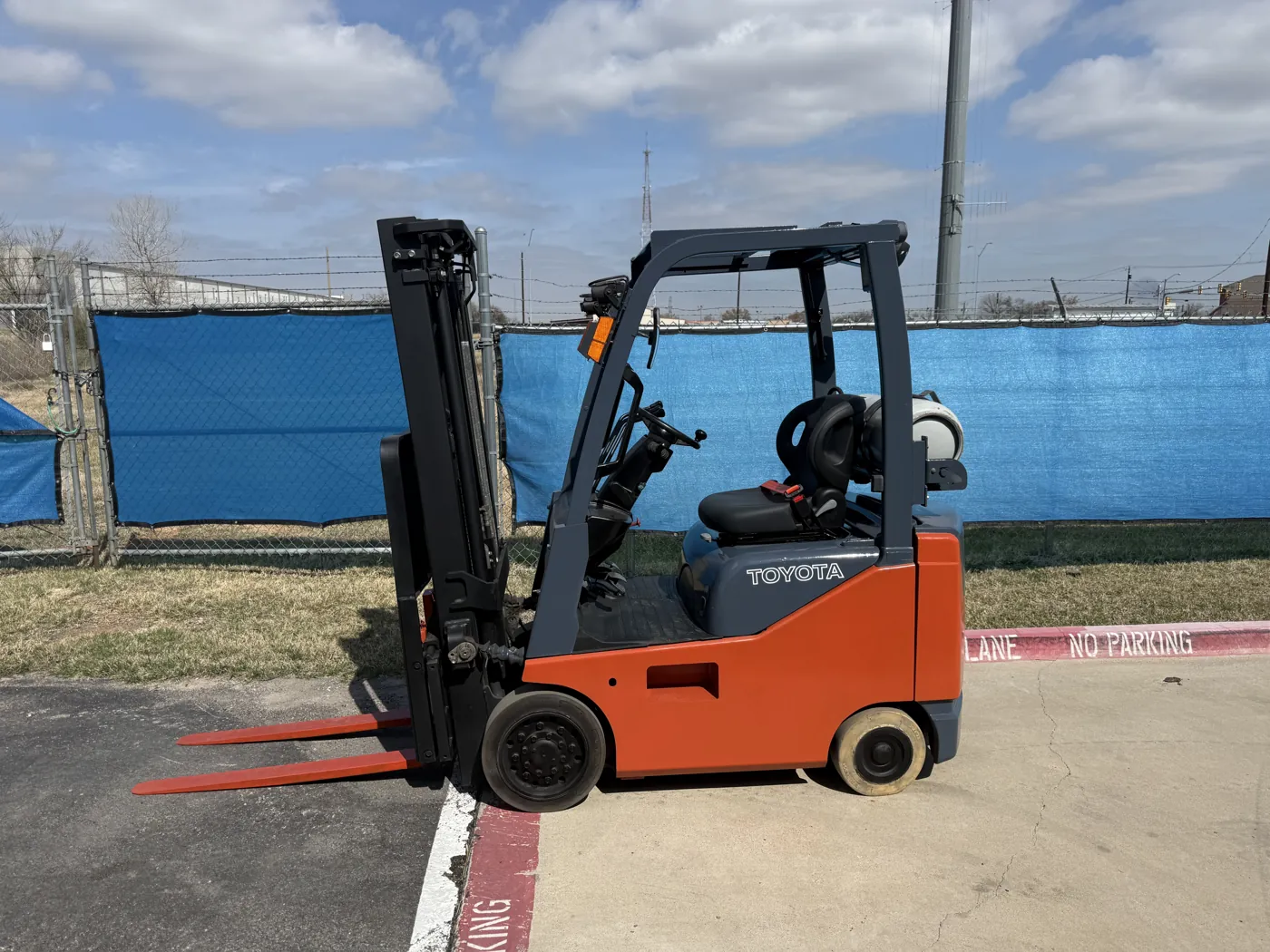 Same Toyota forklift after refurbishment, with fresh paint and a new seat