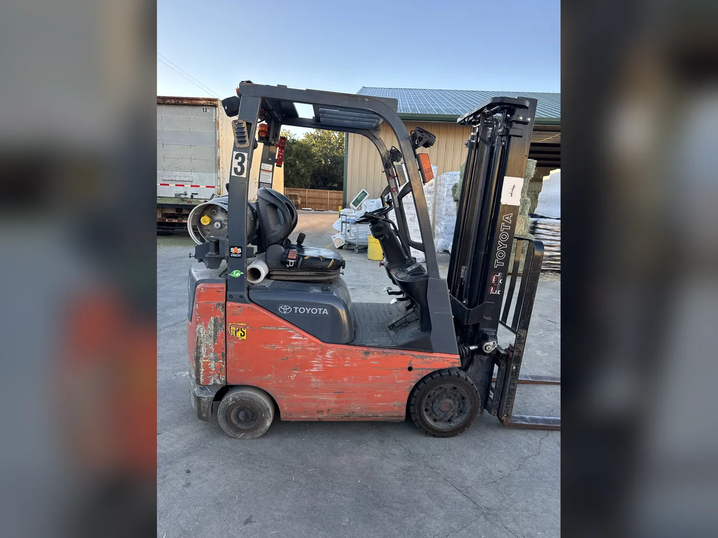 Toyota forklift before refurbishment, with scraped, faded paint