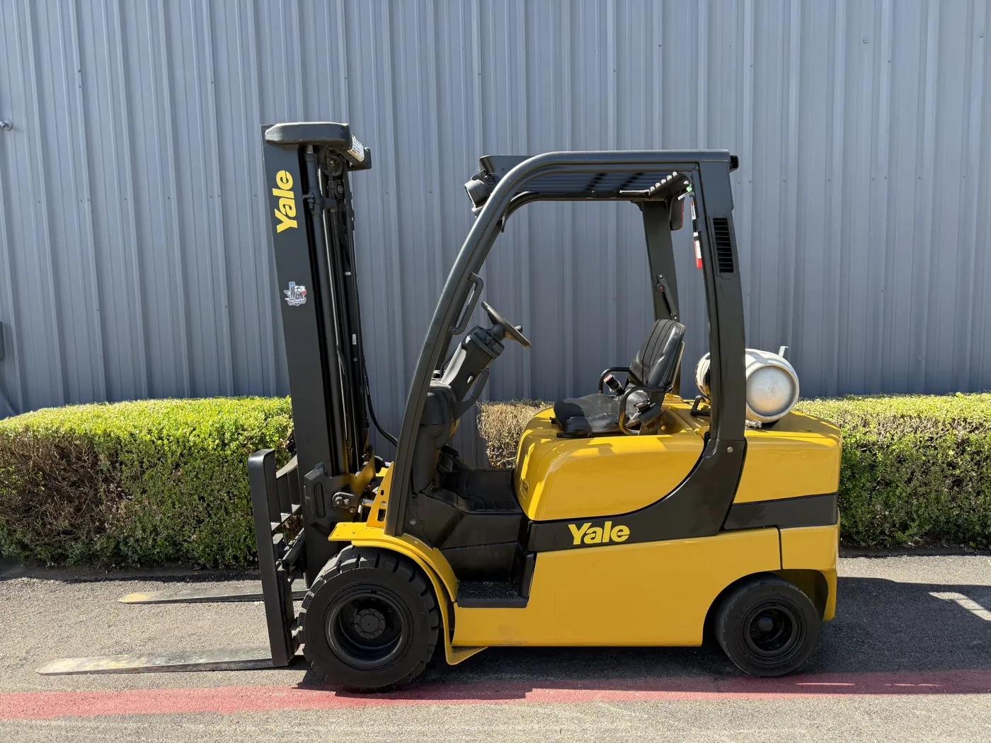 Same Yale forklift after refurbishment, with fresh yellow paint